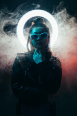 Future girl. Cyberpunk portrait. Artificial life. Blue neon light Asian girl in black leather...