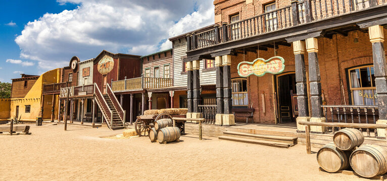 Vintage Far West town with saloon. Old wooden architecture in Wild West.