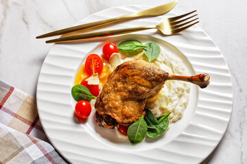 Roasted duck leg with puree and orange sauce