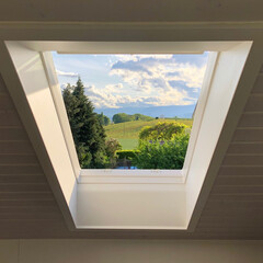 Low angle shot of a beautiful landscape seen from an attic window