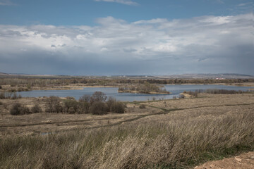 The beautiful nature of the southern Urals. Steppes and a lake in the distance. Sunny day. Blue sky. Beautiful landscape.