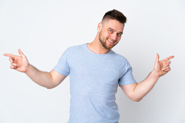 Fototapeta premium Russian handsome man over isolated background pointing finger to the laterals and happy