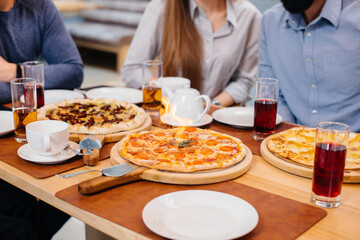 Obraz na płótnie Canvas Unique hot pizza on fire close-up during a friendly dinner.