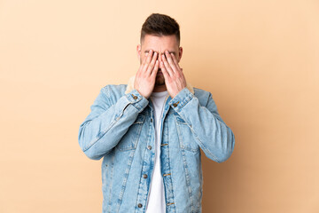 Russian handsome man over isolated background covering eyes by hands