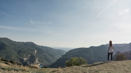 Obraz premium young hiker girl up all over the mountain looking at the landscape