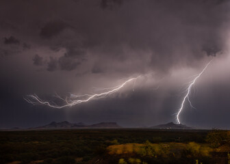 Obraz na płótnie Canvas Lightning Bolts Over Desert Mountains