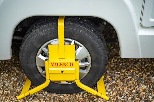 Norwich, Norfolk,UK - May 15 2021. Heavy duty Milenco branded wheel clamp on the rear wheel of a coach built motorhome