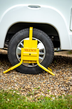Heavy duty Milenco branded wheel clamp on the rear wheel of a coach built motorhome