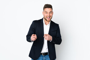 Young Russian business man isolated on white background points finger at you