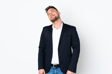 Young Russian business man isolated on white background laughing and looking up