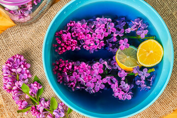 Obraz na płótnie Canvas homemade lemonade with lilac flowers and lemon in jar