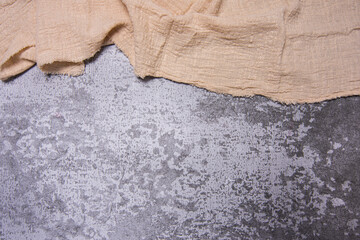 Cracked stone, concrete texture backround, copyspace and top side frame created by beige kitchen table cloth