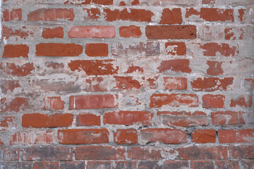 Old dirty brick wall with concrete smudges as background