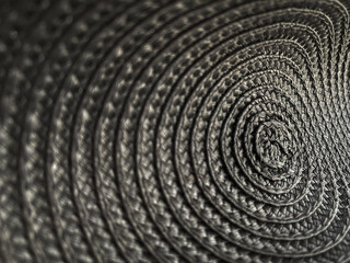 Fototapeta na wymiar Abstract grey colour background from circular wicker pattern texture. Selective focus.