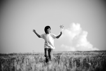 Happy kid running on beautiful field
