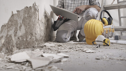 house renovation concept, construction worker use computer, protective construction work tools,...