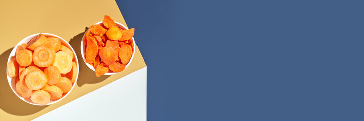 Crispy dried food. Organic tasty chips. Homemade snacks. Sliced carrot. Healthy vegetables. Orange pile Trend natural dish. Horizontal banner. Copyspace