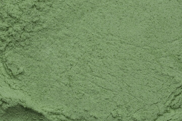 Green powder textured background, close up