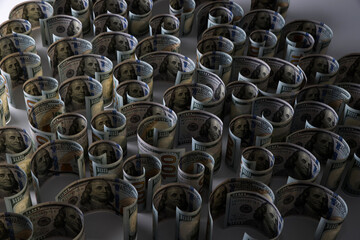 Close-up of one hundred dollar bills rolled into a roll on white background