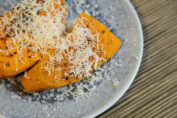 View of delicious sweet potatoes dish.Delicious sweet potatoes on plate high angle.Sweet potatoes with parmigiano