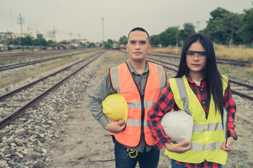 Two engineer working at train station,Work together happily,Help each other analyze the...
