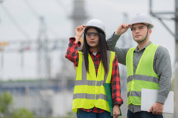 Two engineer working at power plant,Work together happily,Help each other analyze the problem,Consult about development guidelines