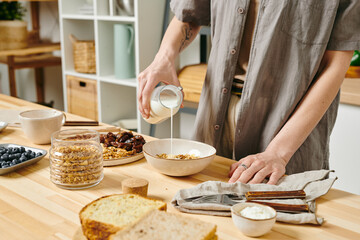Young woman preparing food on a table in the morning