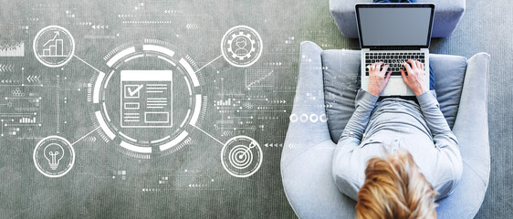 Project management theme with man using a laptop