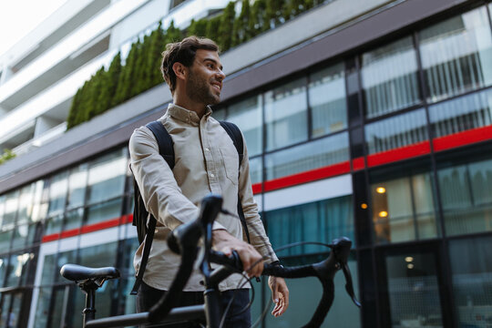 Businessman Commuting To Work With His Bicycle