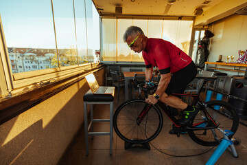 Senior man on exercising bicycle