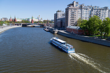 Pleasure boats ride on the Moscow River near the Kremlin.