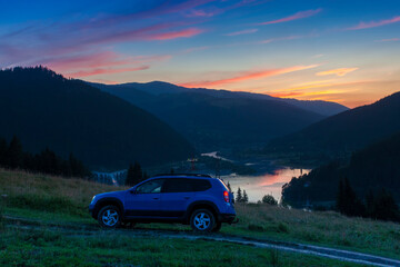 Fototapeta na wymiar Off Road car in mountain sunset landscape, Romania
