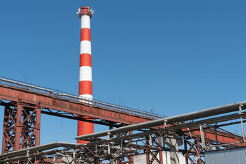 Pipes and other metal structures close-up. Flue gas emissions and atmospheric air pollution. Horizontal gas exhaust pipes on the territory of the factory