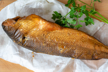 Smoked whitefish on a wooden board.
