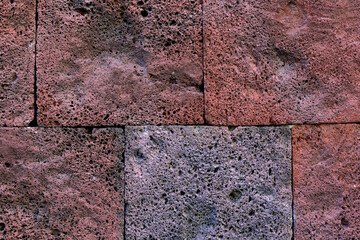 Texture of bricks made of stone. Stone wall from colonial times.