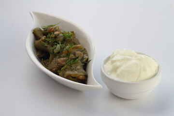 Broad bean and dill in the white plate with white background. With yoghurt