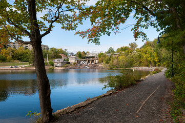 Fototapeta na wymiar Lakeside exercise path leading to hydro dam in Bracebridge, Ontario