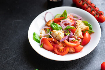 panzanella salad tomato, croutons, onion, olive oil, rusk on the table healthy food meal snack copy space food background rustic. top view keto or paleo diet veggie vegan or vegetarian food