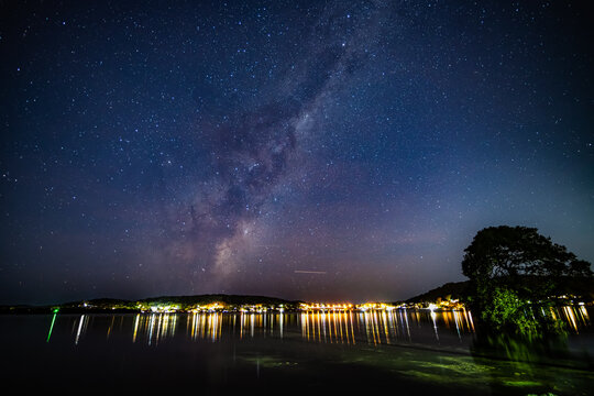 Stars, city lights and the milky way over the bay