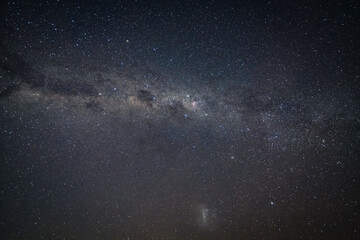 In the dark of the night the stars and milky way sky shine brightly
