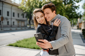 Young happy beautiful couple in the street.