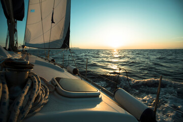 An sail luxery Boat in regatta during sunset.