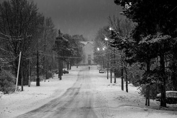 View of the winter street of one of settlements of Leningrad region, Russia. Black and white photo.