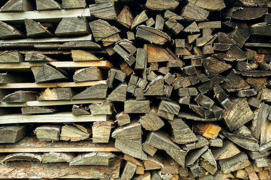 The texture of wood firewood stacked in a woodpile.