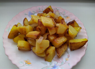 homemade fried potatoes with onions in a plate