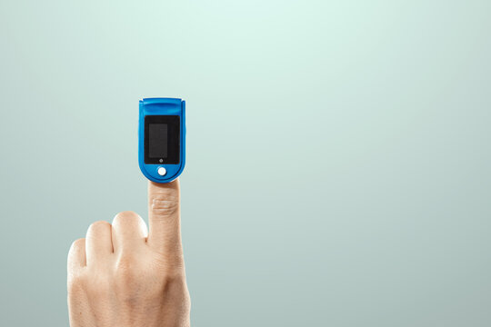 Pulse oximeter, digital device for measuring blood oxygen saturation and pulse rate on the finger. Medical research, close-up.