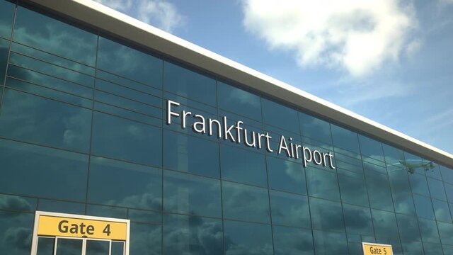 Commercial plane take off reflecting in the windows with Frankfurt Airport text