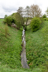 Water in a man-dug trench. Water drainage channel. Spring season.