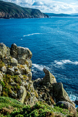 Cliffs by a blue sea with natural white foam