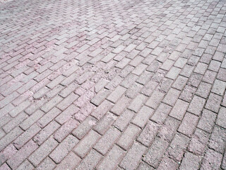 Worn out paving stone, pedestrian walkway, pavement close up in the perspective, the texture.